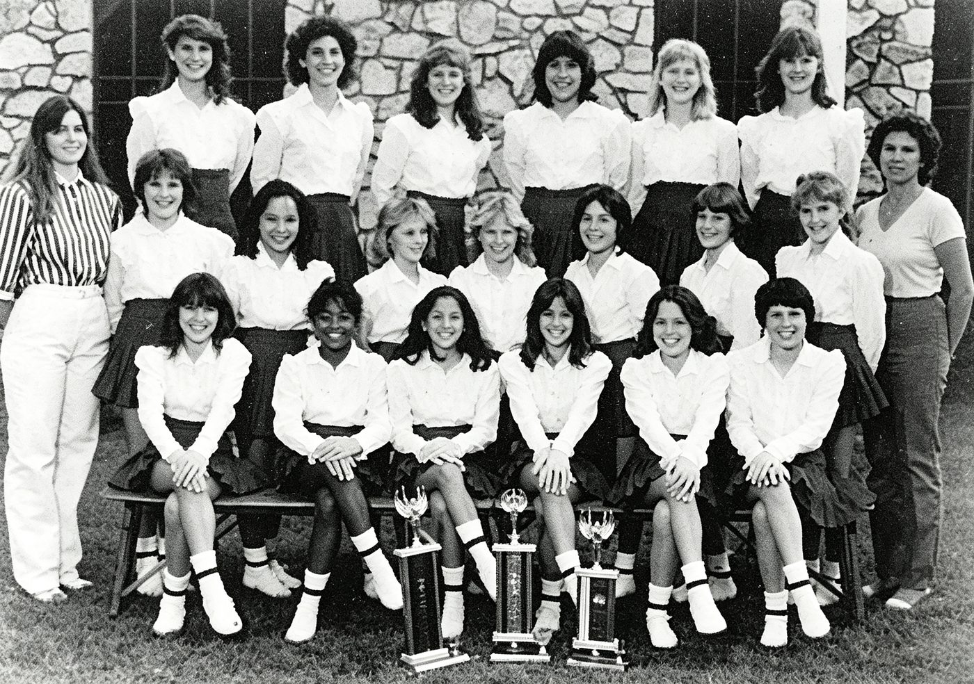 The South Hills Academy drill team seated with trophies
