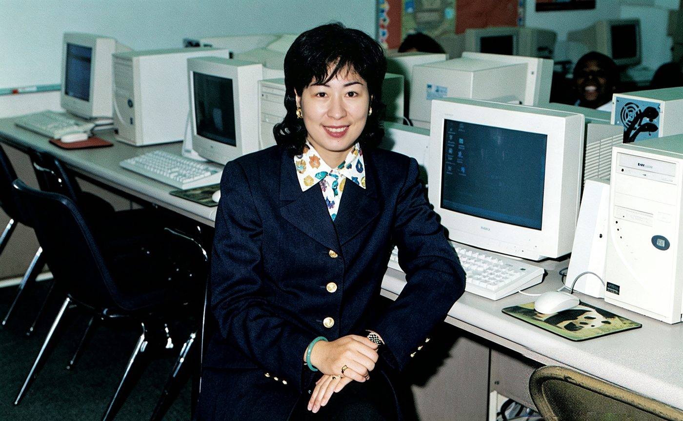 A teacher in the computer lab full of CRT monitors
