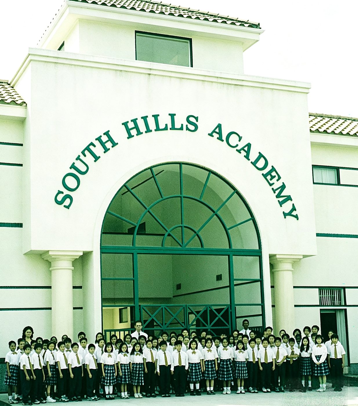 Students gathered under the new arched entrance reading South Hills Academy