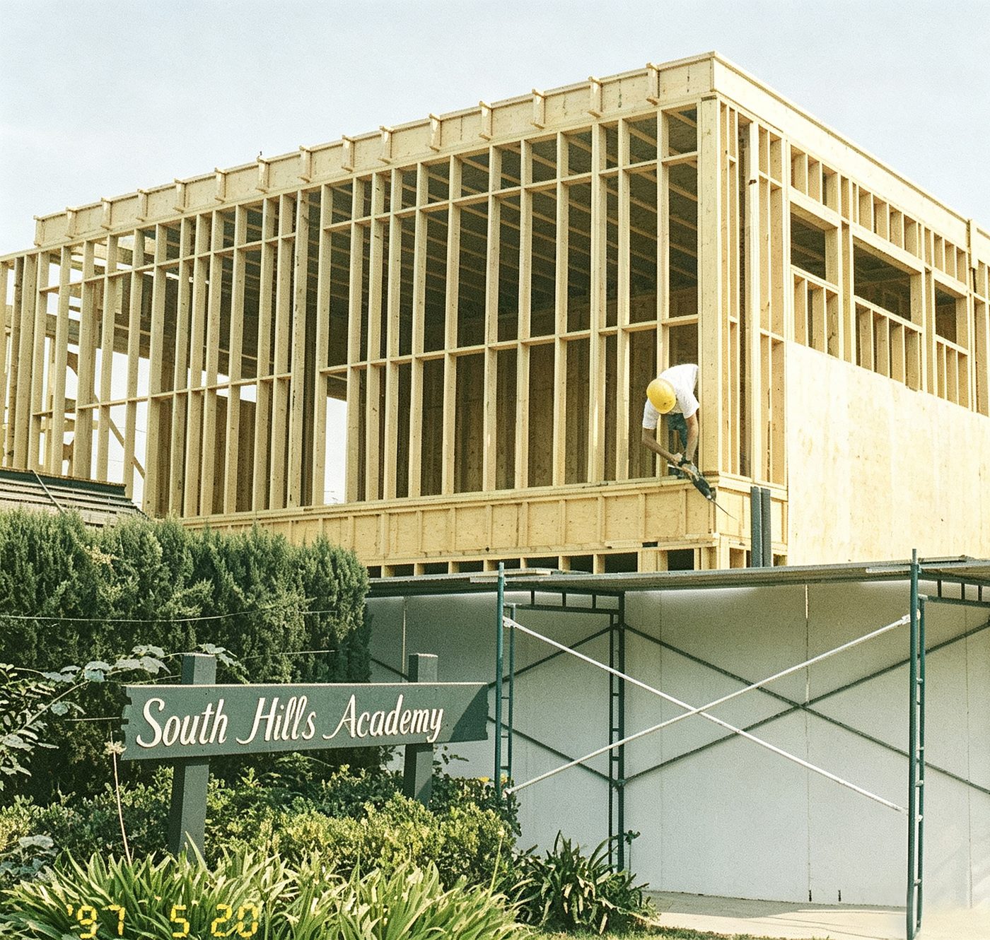 A campus building under construction with the South Hills Academy sign