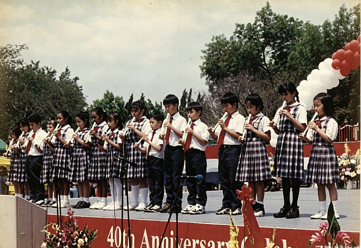Uniformed students perform on the 40th anniversary stage