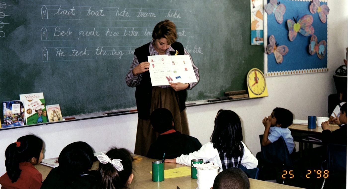 A teacher reads a picture book to the class
