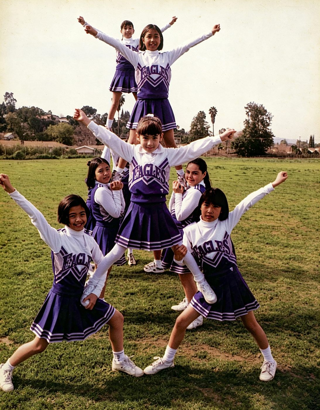 South Hills Eagles cheerleaders in purple uniforms form a pyramid