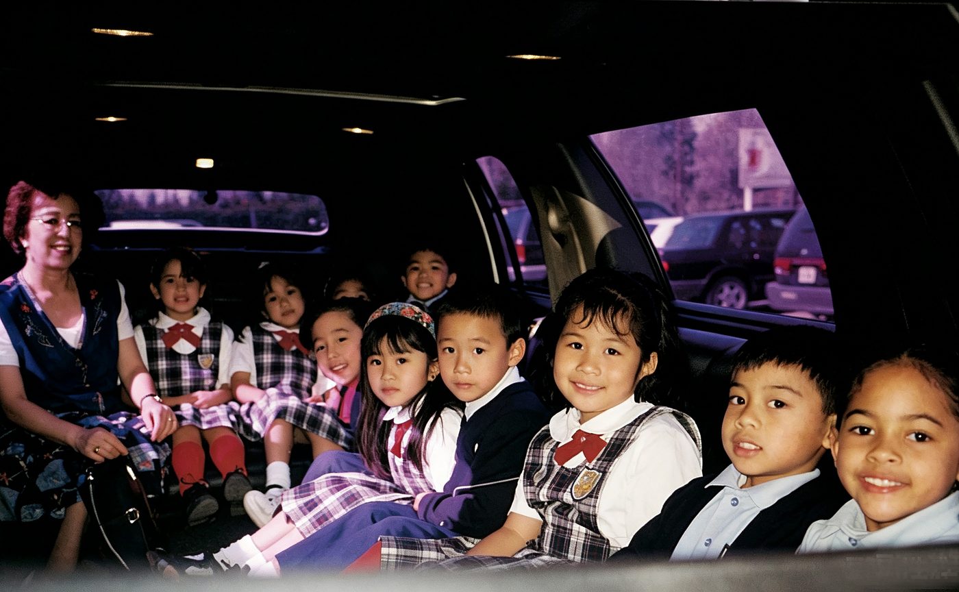 Young students ride in a limousine on a school outing